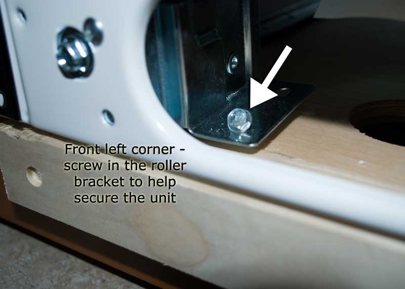 Screw into the front left corner of the roller plate